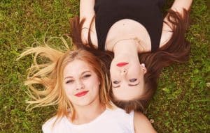 ŽENE KOJE LEŽE NA TRAVI- UPALA JAJNIKA KOD ŽENA-SIMPTOMI-LEČENJE